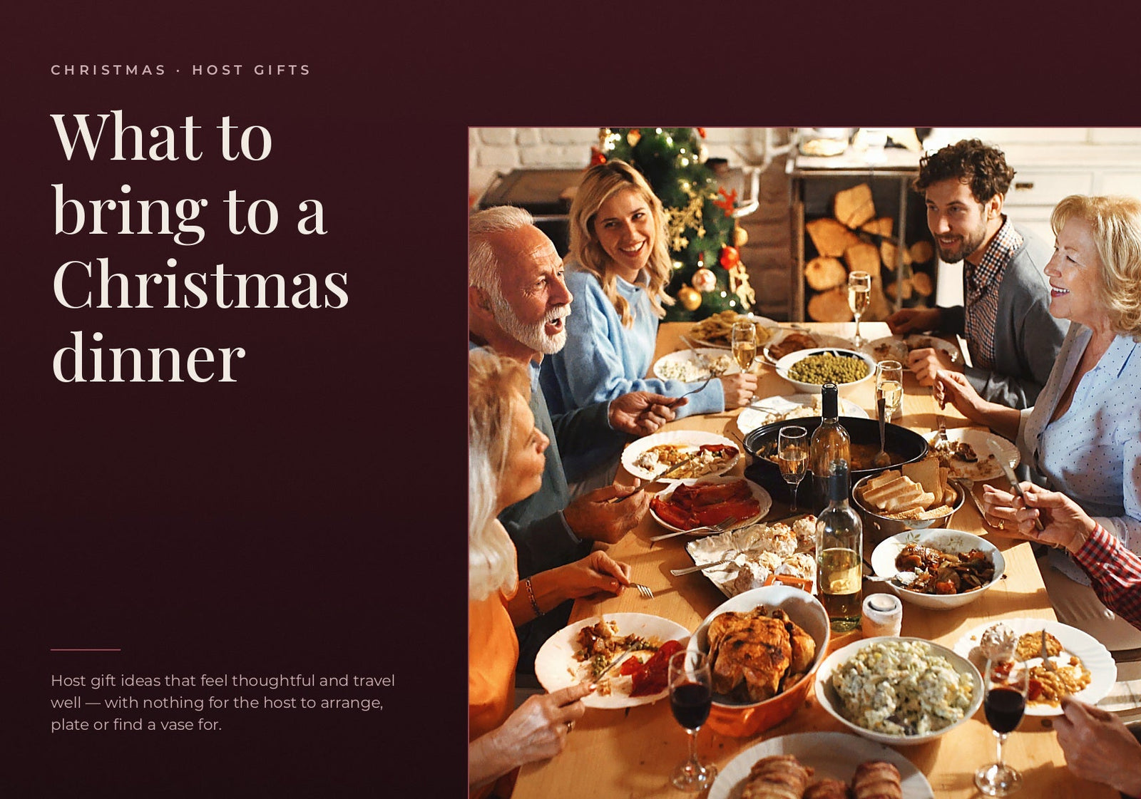 A multi-generational family and friends smiling and enjoying a Christmas dinner together around a table with food and wine.  