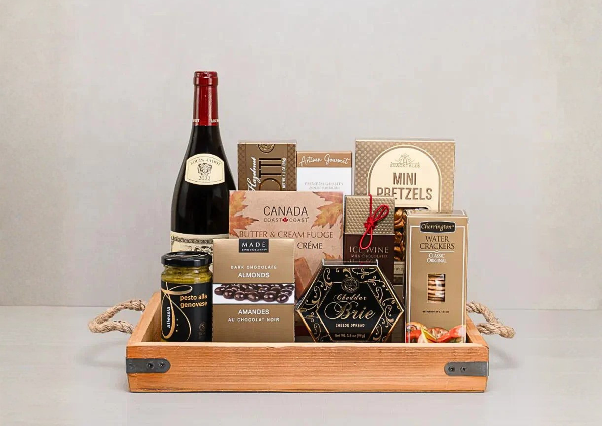 Same-day Toronto gift basket delivery featuring premium wine, artisan snacks, and chocolates in a wooden tray.