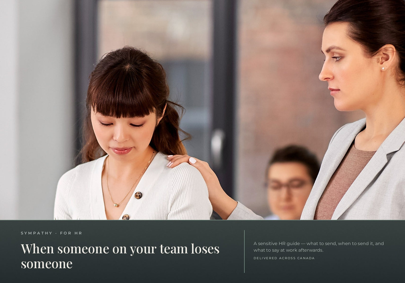 A supportive colleague placing a comforting hand on an employee's shoulder in the workplace.