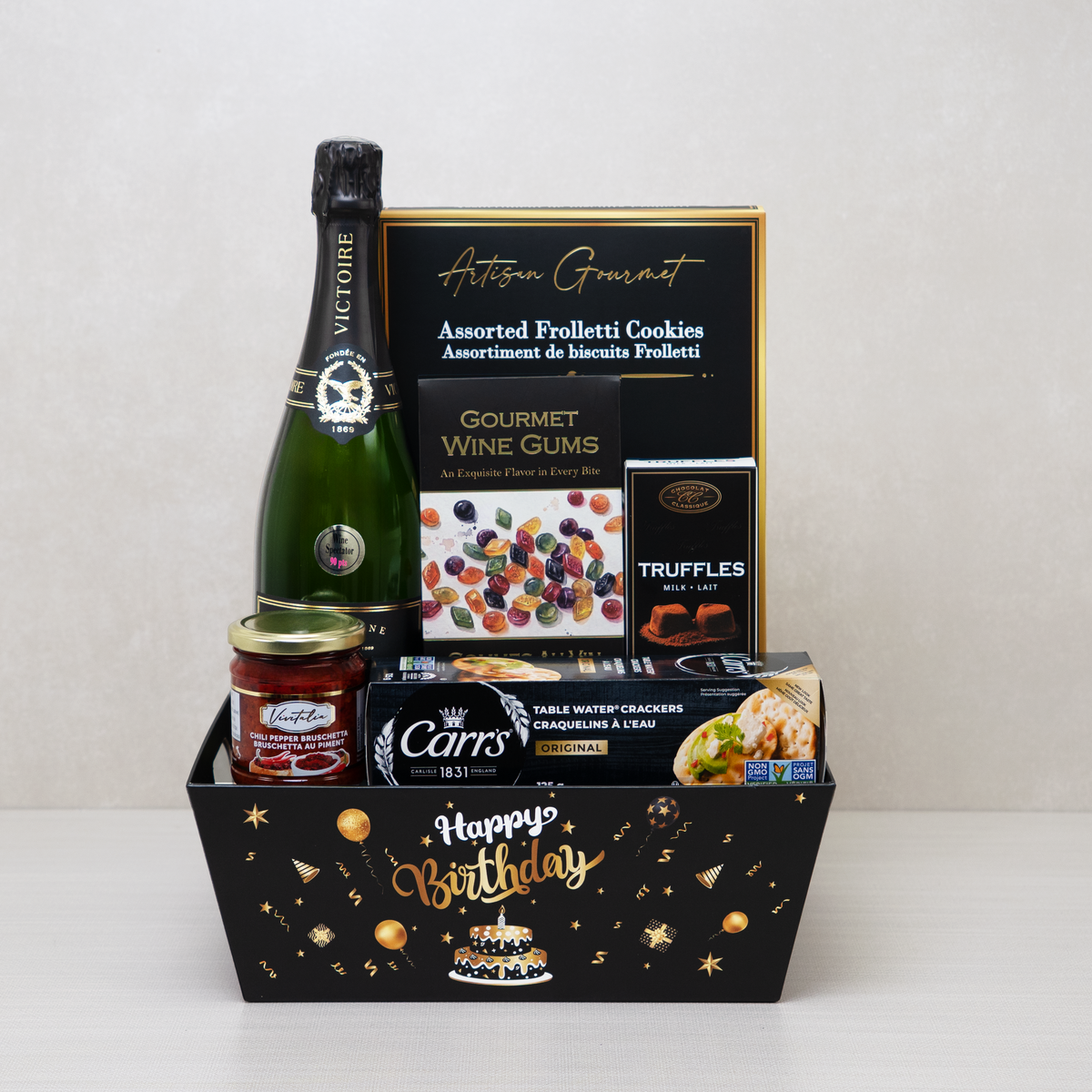 Birthday Celebration with Champagne basket with champagne, sauce, truffles, wine gums, and water crackers.