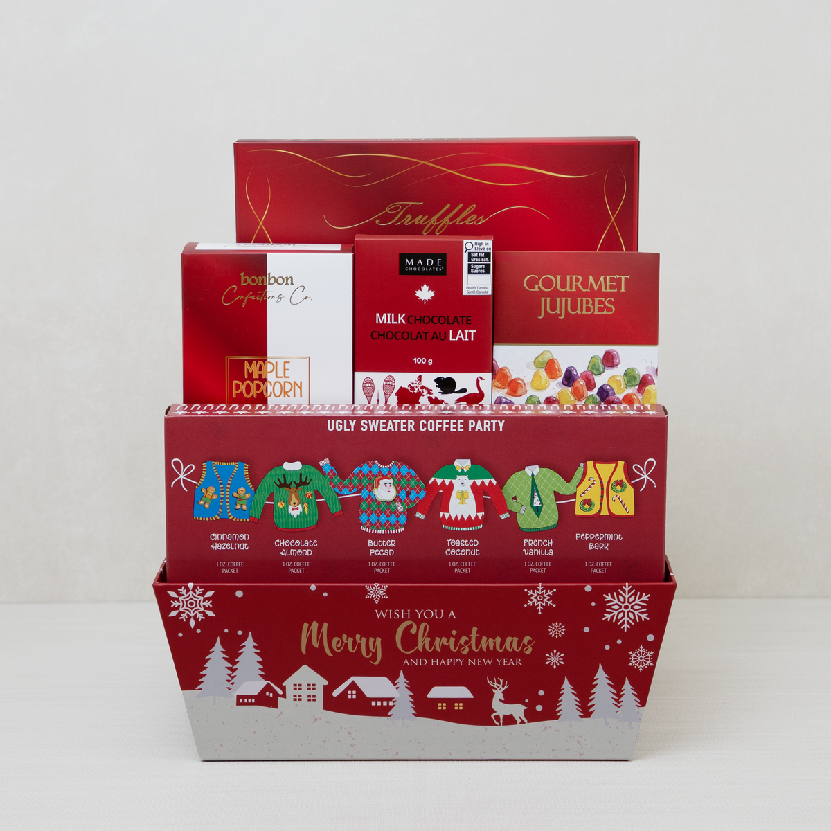 Christmas Goodies Gift Basket with six flavoured coffees, cocoa truffles, maple popcorn, and wine gums in a festive basket.