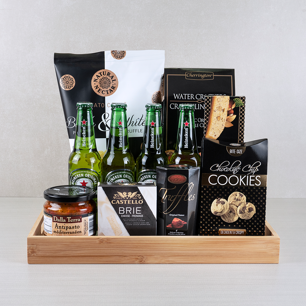 Premium Tastes Gift Basket with four Heineken bottles, Castello brie, truffle chips and antipasto in a bamboo tray