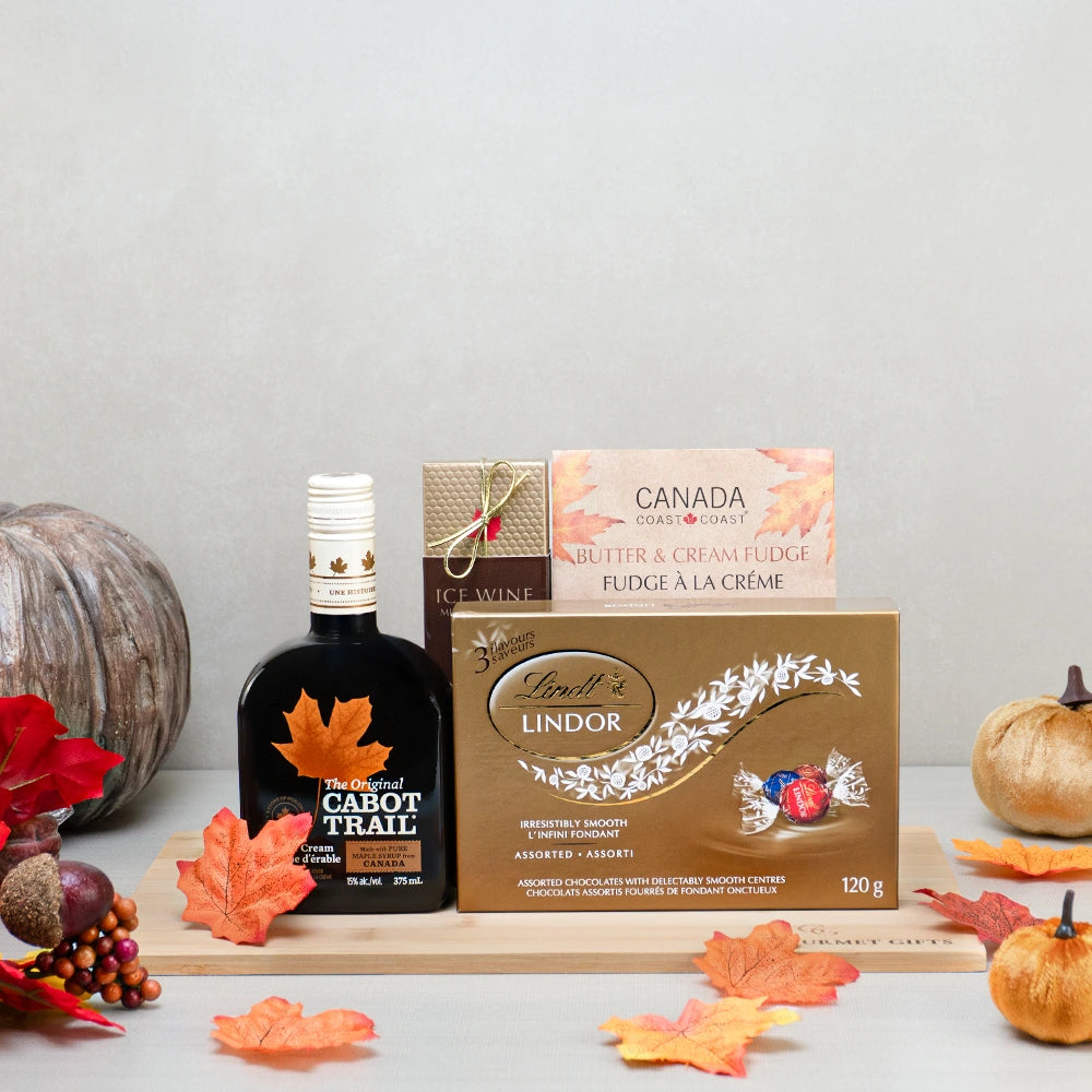 Fall Flavors Gourmet Basket with Cabot Trail maple cream liqueur, Lindt Lindor, icewine chocolates and fudge on a wood board