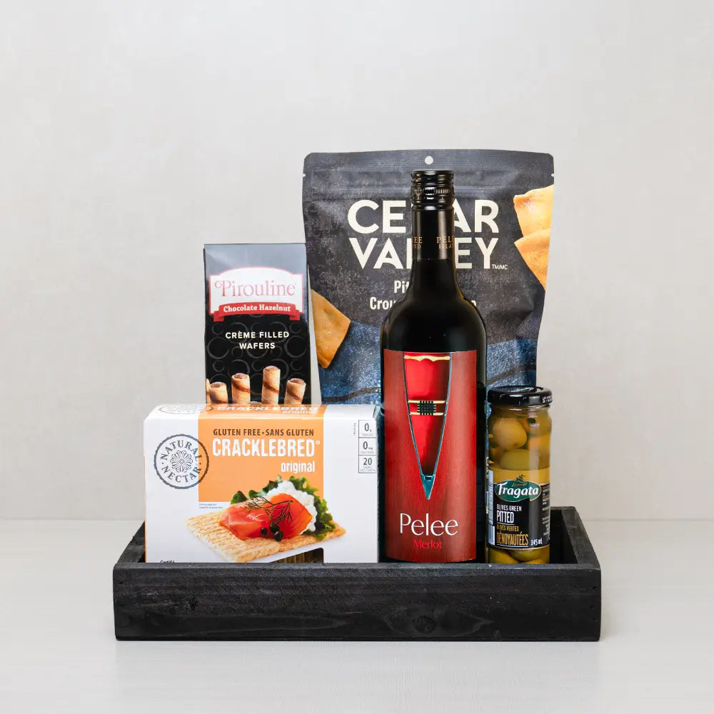 Executive Excellence Corporate Gift Basket with Pelee Merlot, pita chips, green olives and Pirouline wafers on a black tray
