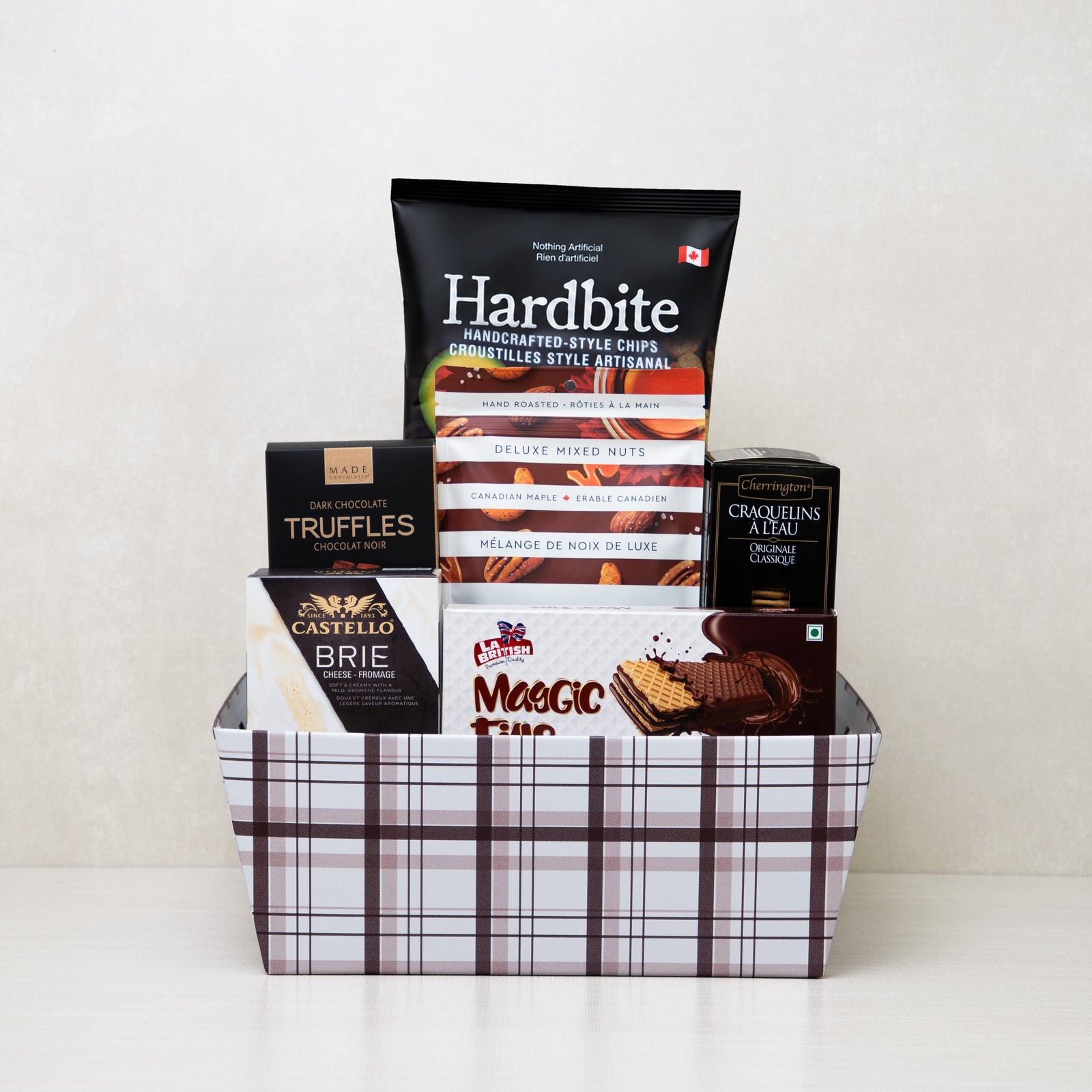 Gourmet Favourites Basket: Chips, brie cheese, mixed nuts, truffles, and crackers in a basket.