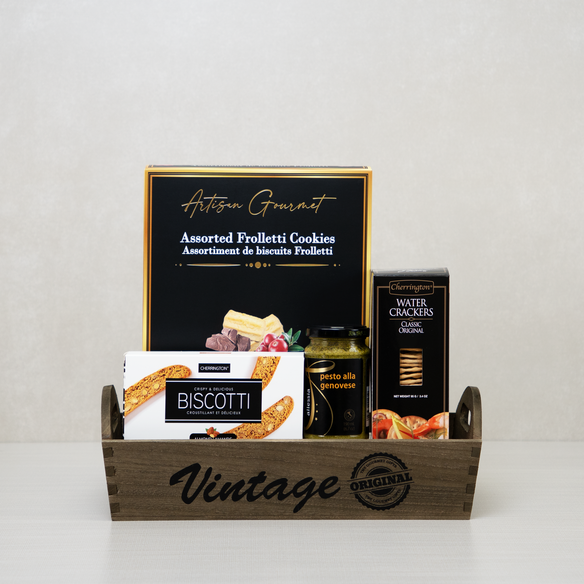 Gourmet Snack Vintage Tray with cookies, biscotti, crackers, and pesto on a rustic wooden tray.
