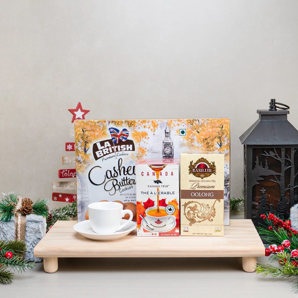 Holiday Tea & Cookie Basket with La British cashew butter cookies, maple tea and Basilur oolong tea on a footed wooden tray