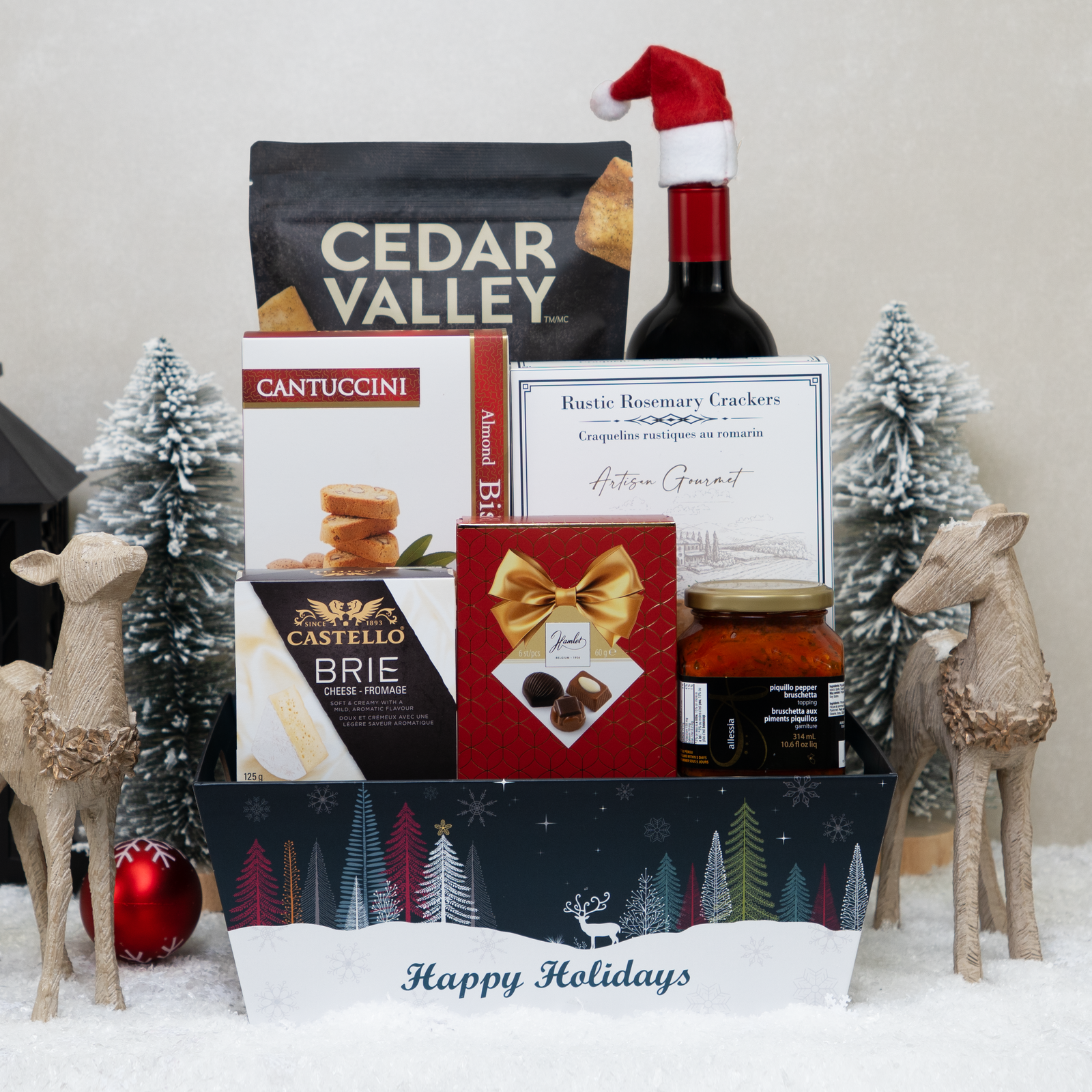 Holidays Cheer gift basket with red wine, brie, crackers, chips, and Belgian pralines.