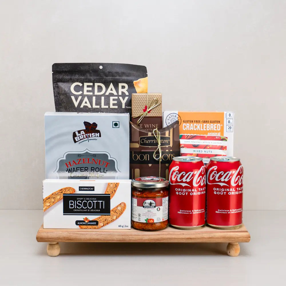 Share & Enjoy Snack Gift Set with two Coca-Colas, Cedar Valley pita chips, hazelnut wafer rolls and biscotti on a footed tray