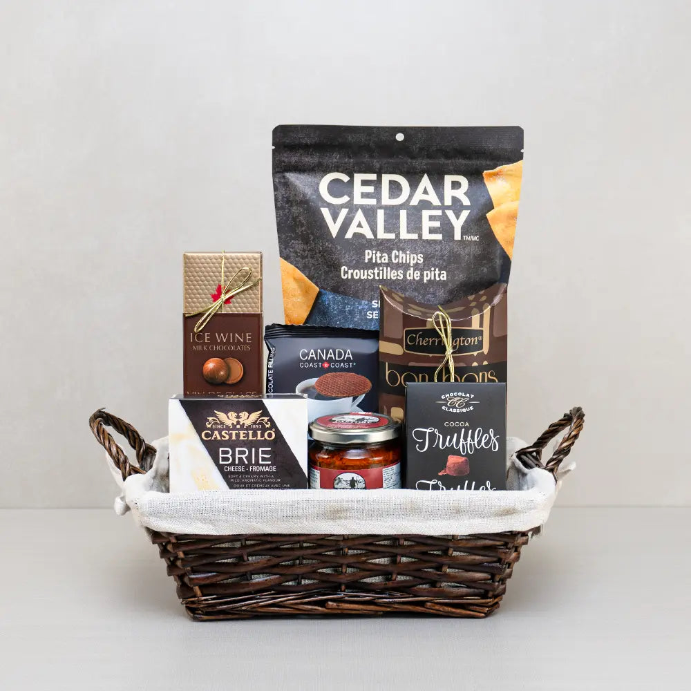 Canadian Gourmet Treat Basket with ice wine chocolates, Castello brie, cocoa truffles and pita chips in a lined wicker basket