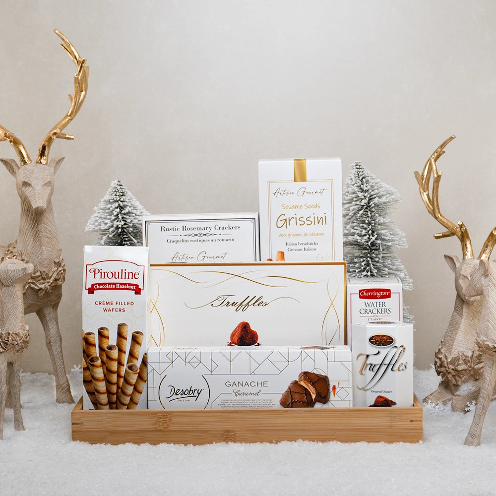 Merry & Bright Basket with Pirouline wafers, cocoa truffles, Desobry caramel biscuits and sesame grissini on a bamboo tray
