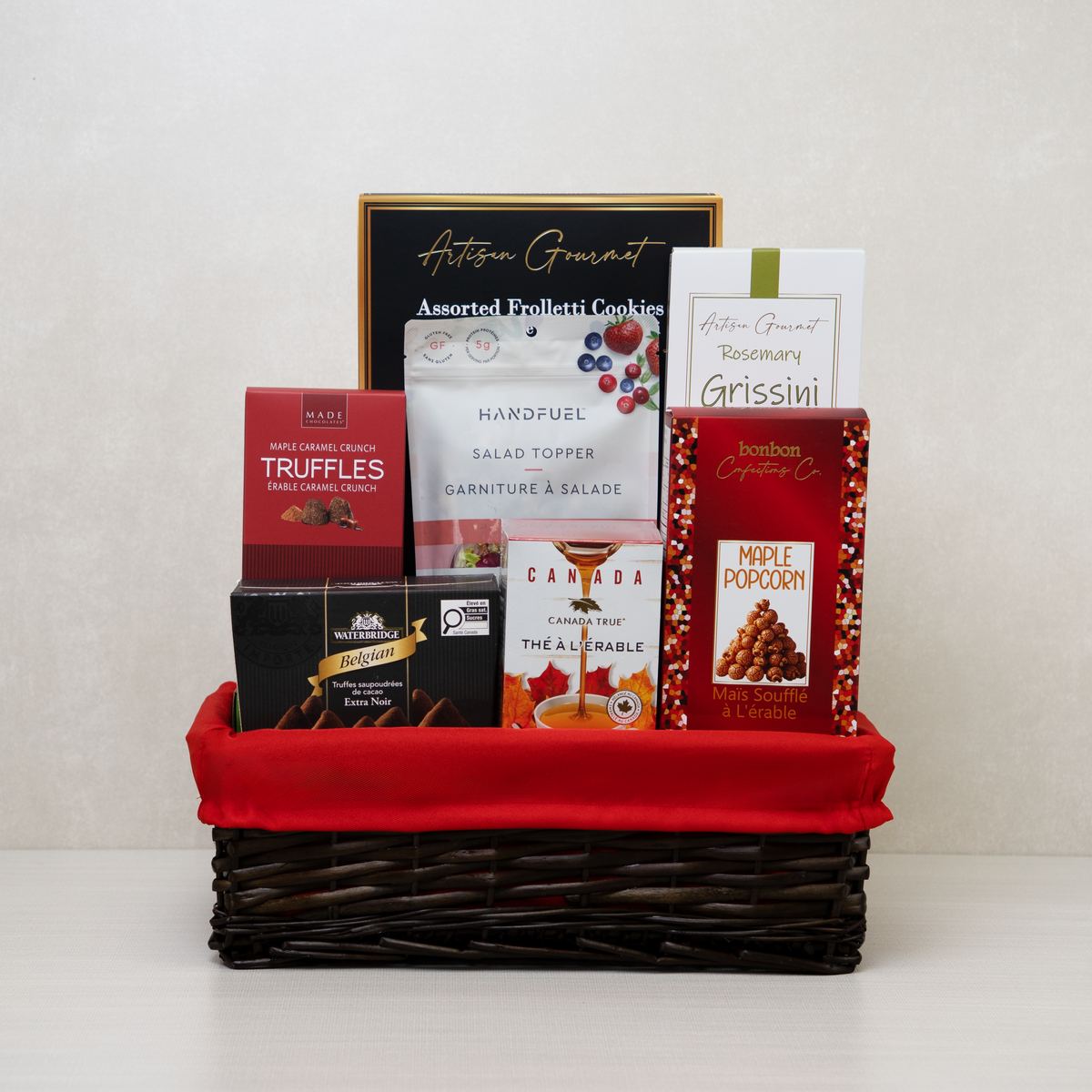 Merry & Gourmet Gift Basket with popcorn, tea, truffles, breadsticks, cookies, and more.