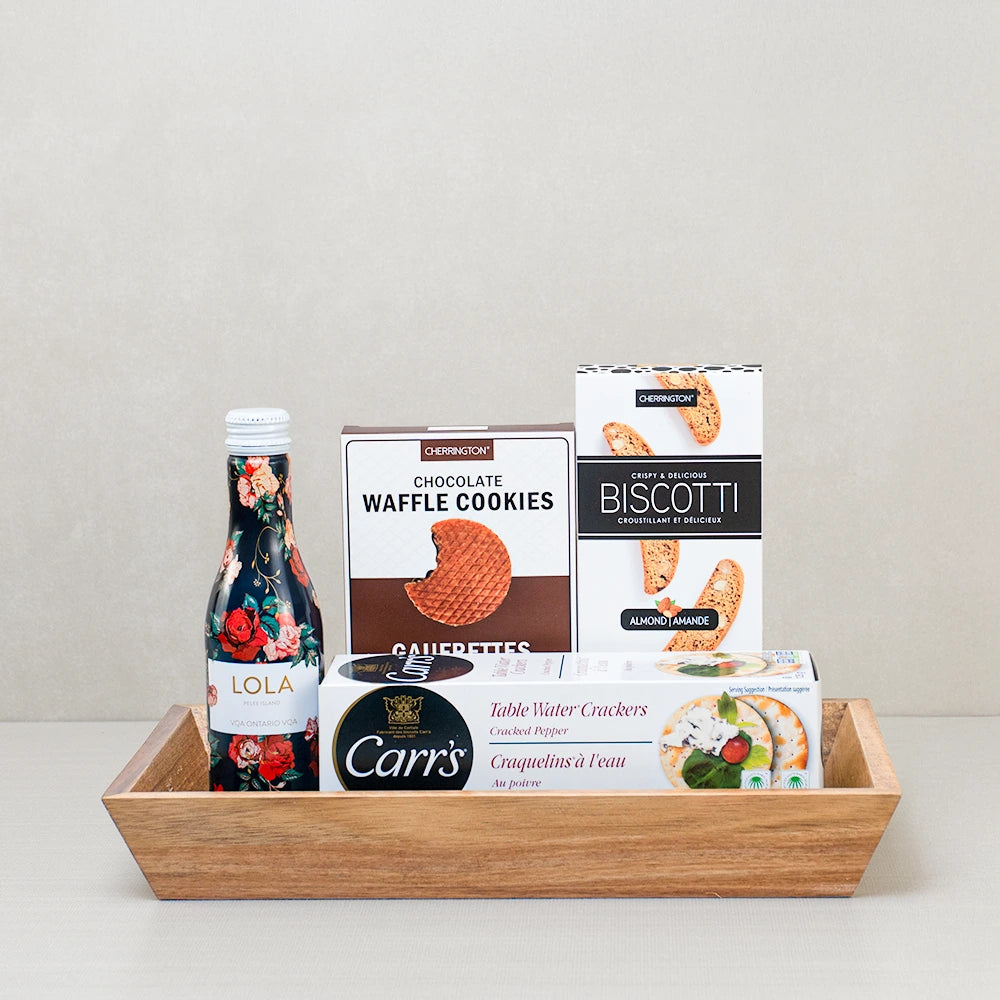 Mini Rosé & Gourmet Snacks Basket with LOLA sparkling rosé, Carr's crackers, biscotti and waffle cookies on a wood tray