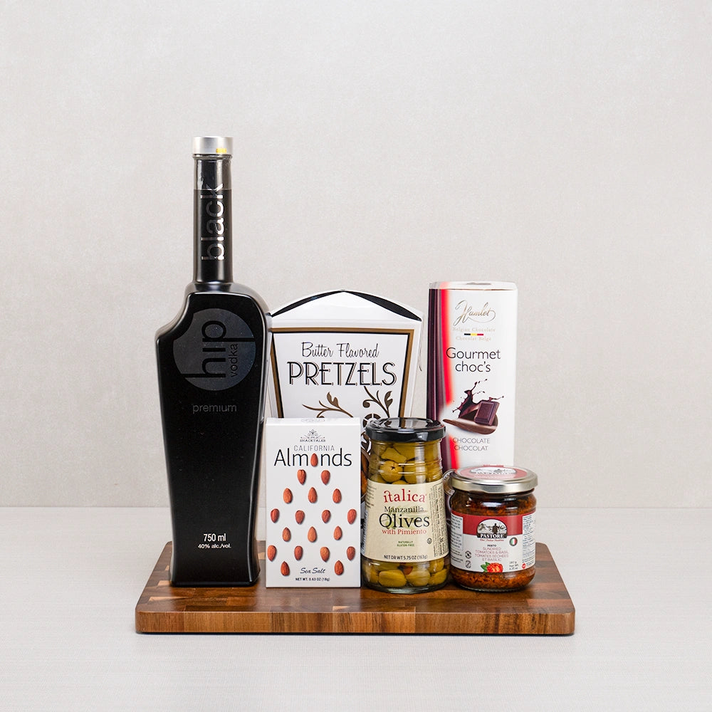 Luxury Vodka Pairings Gift Set with Hip vodka, Italica olives, Hamlet chocolates, butter pretzels and Pastore pesto on acacia