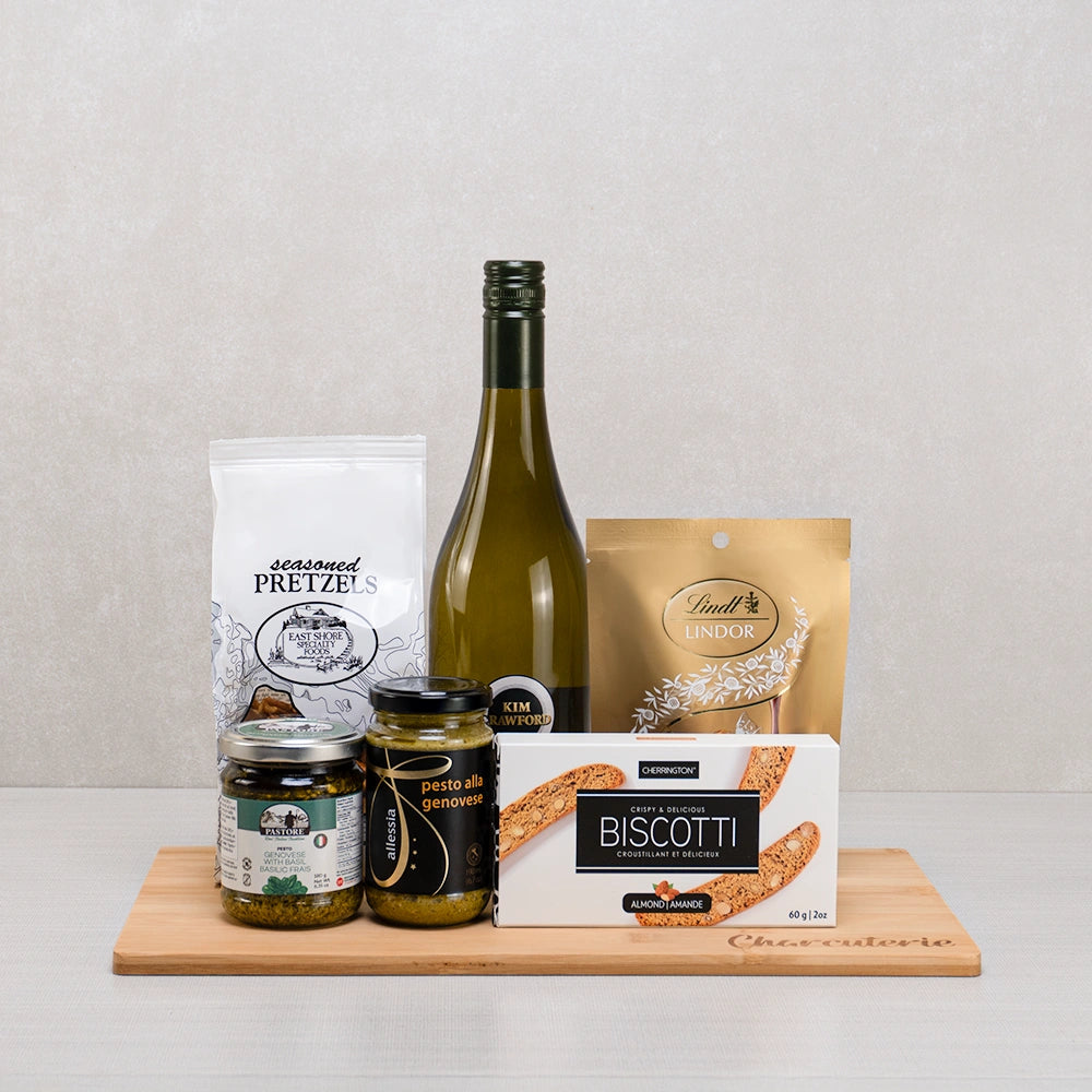 Gourmet Charcuterie with Wine & Pretzels gift basket: Kim Crawford white wine, Lindt Lindor, two pestos and almond biscotti