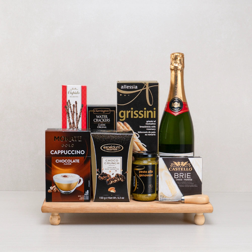 The Supreme Luxe Treat Collection with sparkling wine, Castello brie, Mokate cappuccino and grissini on a footed board