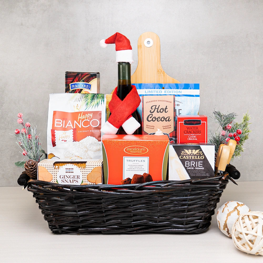 Holiday Bliss Wine & Snacks Basket with wine in a Santa hat and scarf, Castello brie, Excelcium truffles and hot cocoa