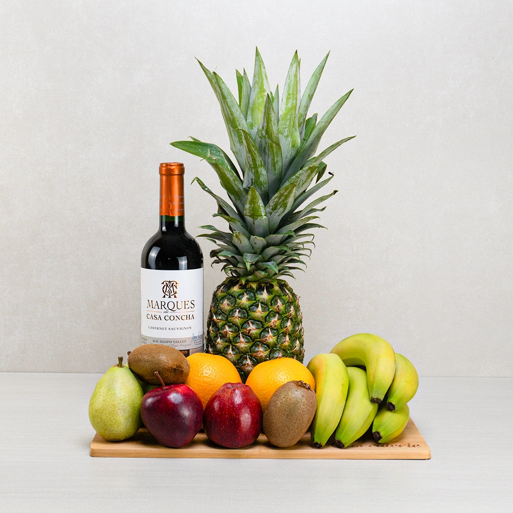 Thoughtful Comfort Fruits and Wine Basket with Casa Concha Cabernet, pineapple, bananas, apples and oranges on bamboo