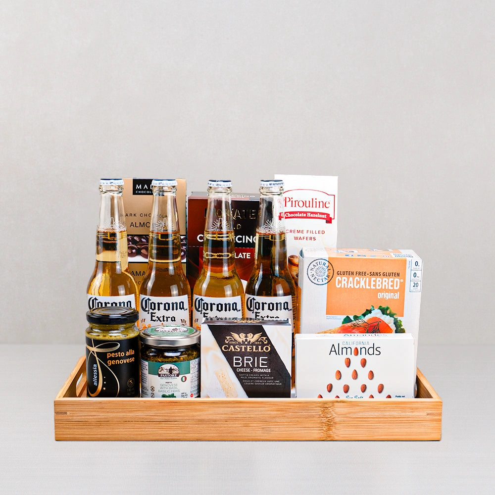 Corona Extra & Gourmet Bites Gift Set with four Corona beers, Castello brie, two pestos and Pirouline wafers in a bamboo tray
