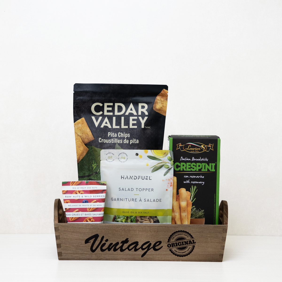 Vegan Gourmet Vintage Tray: Rosemary breadsticks, pita chips, salad topper, and berry nut mix on a rustic wooden tray.