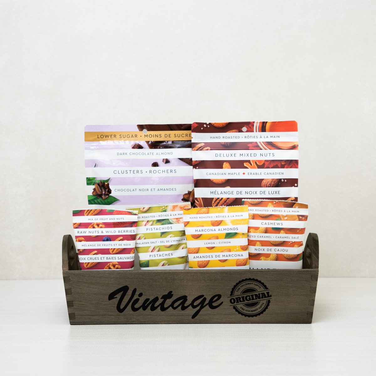 Vintage Nut Collection Tray: Mixed nuts, dark chocolate almonds, pistachios, and cashews arranged in a wooden tray.