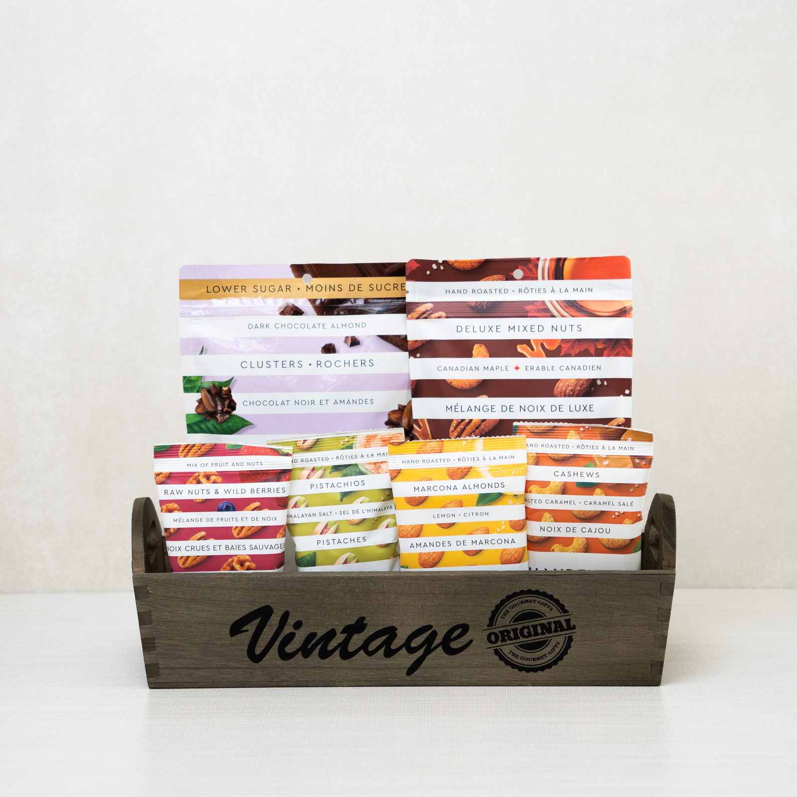 Vintage Nut Collection Tray: Mixed nuts, dark chocolate almonds, pistachios, and cashews arranged in a wooden tray.