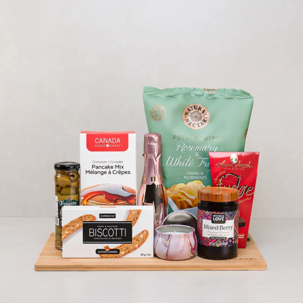 Brunch & Bubbles Mother’s Day Basket with mini sparkling rosé, a marbled candle, truffle chips, pancake mix and biscotti