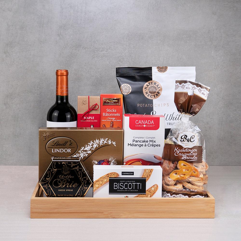 Deluxe Client Appreciation Basket: red wine, Lindt Lindor, cheddar brie spread, pancake mix and pretzels in a bamboo tray