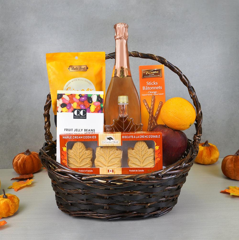 Harvest Celebration Gourmet Basket with sparkling wine, maple syrup in a leaf bottle, maple cream cookies and jelly beans